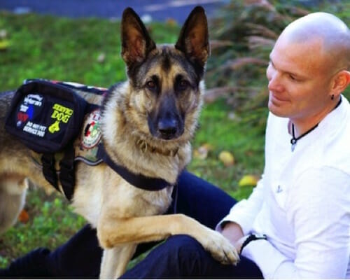 axel the hero dog poses with Captain Jason Haag