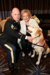 Chuck Shuck, Betty White, Gabe the hero dog pose for camera