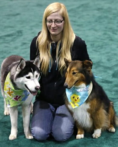 Ashley poses with her best friends Siberian Husky Maya and collie Mickie