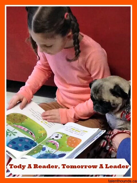 little girl reads to therapy pug