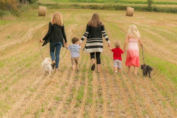 Parker family walking dogs in field