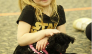 girl with black puppy