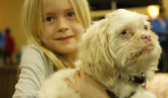 girl holds white dog
