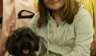 girl with black puppy