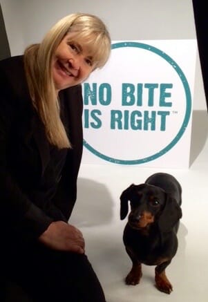 Susie and Crusoe with No Bite is Right sign