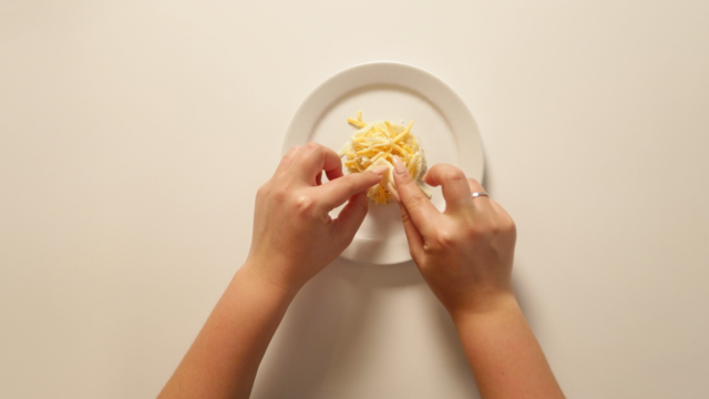 adding cheese to the grilled cheese dog treat