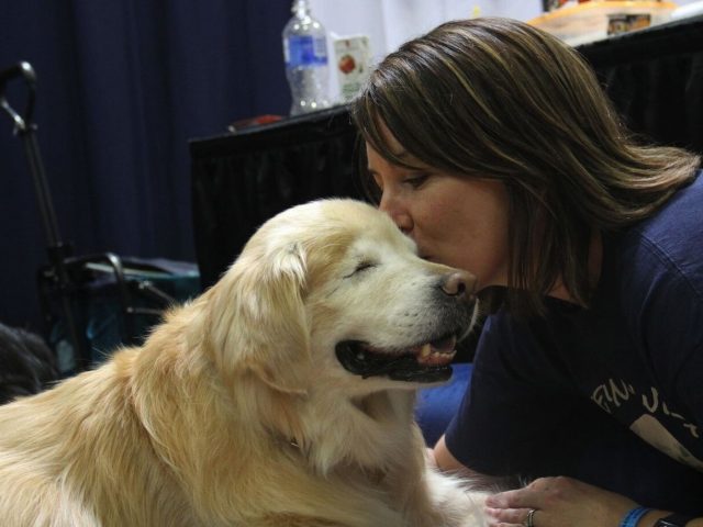 Smiley the Blind Therapy Dog and his Mom Joanne sharing a secret at Canadian Pet Expo