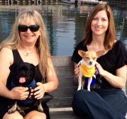 photo of susan and Kilo the pug with marybeth and her chihuahua sitting by the water for her interview