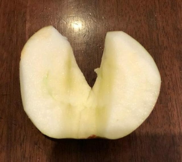 A cored heart-shaped half apple
