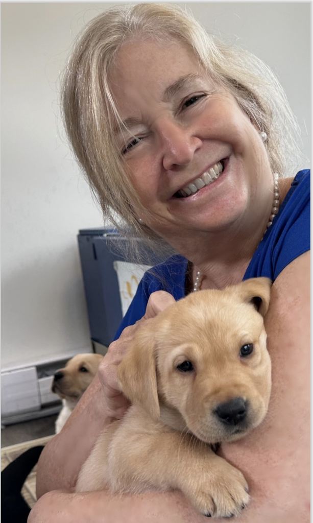 Pet parent Susie getting some love from COPE future service puppy.